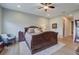 Spacious primary bedroom with wood floors, a ceiling fan, a rug, and elegant furniture at 3409 Lake Diane Rd, Tavares, FL 32778
