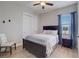 This bedroom features a ceiling fan, closet, and a dark wood framed bed with decorative pillows at 3409 Lake Diane Rd, Tavares, FL 32778