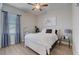 This bedroom features light wood flooring, a ceiling fan, and bright natural light at 3409 Lake Diane Rd, Tavares, FL 32778