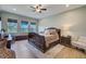 Spacious primary bedroom featuring multiple windows, a ceiling fan, and wood floors at 3409 Lake Diane Rd, Tavares, FL 32778