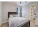 The bedroom has a dark wood framed bed, light wood floors, and a window at 3409 Lake Diane Rd, Tavares, FL 32778
