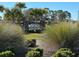 Welcoming stone community sign for Hidden River Lakes amidst lush landscaping and palm trees at 3409 Lake Diane Rd, Tavares, FL 32778