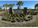 Welcoming stone community sign for Hidden River Lakes amidst lush landscaping and palm trees at 3409 Lake Diane Rd, Tavares, FL 32778