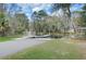 Lakeside dock featuring a ramp, a covered gazebo, and scenic views surrounded by mature trees at 3409 Lake Diane Rd, Tavares, FL 32778
