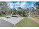 Lakeside dock featuring a ramp, a covered gazebo, and scenic views surrounded by mature trees at 3409 Lake Diane Rd, Tavares, FL 32778
