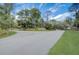 Wide driveway leading to scenic wooded area and tranquil surroundings, perfect for a serene lifestyle at 3409 Lake Diane Rd, Tavares, FL 32778