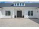 Beautiful modern farmhouse featuring a dark front door and stylish brick driveway at 3409 Lake Diane Rd, Tavares, FL 32778
