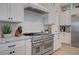 Gourmet kitchen featuring stainless steel appliances, custom cabinets, and granite countertops at 3409 Lake Diane Rd, Tavares, FL 32778