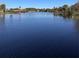 Expansive lake view showcasing calm water and distant waterfront properties on a clear, sunny day at 3409 Lake Diane Rd, Tavares, FL 32778