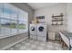 The laundry room has front-load washer/dryer, patterned tile, and ample natural light at 3409 Lake Diane Rd, Tavares, FL 32778