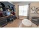 Elegant office with a dark wood built-in desk, shelving, and a large window for natural light at 3409 Lake Diane Rd, Tavares, FL 32778