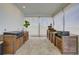 Outdoor kitchen featuring modern appliances, including a grill and pizza oven, with wood cabinetry and a tiled floor at 3409 Lake Diane Rd, Tavares, FL 32778