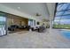Luxury living: covered patio with seamless transition to indoor living, overlooking the pool and lush landscape at 3409 Lake Diane Rd, Tavares, FL 32778