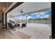 Covered patio featuring comfortable seating and a stunning view of the screened-in pool and yard at 3409 Lake Diane Rd, Tavares, FL 32778