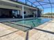Stunning pool and outdoor living area with covered patio, perfect for entertaining and enjoying the serene views at 3409 Lake Diane Rd, Tavares, FL 32778