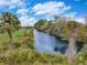 Lush landscaping surrounds a serene canal waterway on a sunny day at 3409 Lake Diane Rd, Tavares, FL 32778