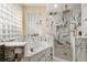 Beautiful bathroom features a soaking tub and a shower with elegant marble-look tiling at 3637 Rothbury Dr, Belle Isle, FL 32812