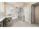 Bright bathroom featuring a soaking tub and shower with marble tiling and decorative shower flooring at 3637 Rothbury Dr, Belle Isle, FL 32812