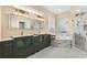 Spa-like bathroom with dual sinks, glass block accents, and a luxurious soaking tub at 3637 Rothbury Dr, Belle Isle, FL 32812