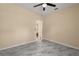 Neutral bedroom with grey marble tile, ceiling fan and an open doorway to the rest of the home at 3637 Rothbury Dr, Belle Isle, FL 32812