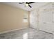 Bright bedroom featuring marble flooring, built in closet and storage space, and a ceiling fan at 3637 Rothbury Dr, Belle Isle, FL 32812
