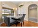 Elegant dining room featuring a modern table, stylish seating, and a view of the screened-in lanai at 3637 Rothbury Dr, Belle Isle, FL 32812