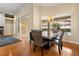 Dining area with a modern table, elegant chandelier, and sliding glass doors providing views of the screened-in pool at 3637 Rothbury Dr, Belle Isle, FL 32812