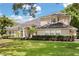 Stunning two-story home with lush landscaping and a well-manicured lawn, showcasing its charming curb appeal at 3637 Rothbury Dr, Belle Isle, FL 32812