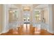 Elegant foyer featuring marble and hardwood floors, complemented by grand columns and abundant natural light at 3637 Rothbury Dr, Belle Isle, FL 32812