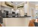 Well-designed kitchen with stainless steel appliances, granite countertops, and a breakfast bar overlooking the dining area at 3637 Rothbury Dr, Belle Isle, FL 32812