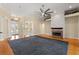 Bright living room with a fireplace, hardwood floors, columns and a view of the foyer at 3637 Rothbury Dr, Belle Isle, FL 32812