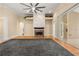 Open living area with hardwood floors, fireplace, ceiling fan and sliding door access to the pool at 3637 Rothbury Dr, Belle Isle, FL 32812