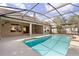 A clear view of the pool area featuring a screened in patio and well-maintained backyard landscaping at 3637 Rothbury Dr, Belle Isle, FL 32812
