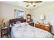 Bright bedroom with two windows, ceiling fan, and vintage dresser at 3970 Kissimmee Park Rd, St Cloud, FL 34772
