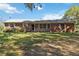 Charming single-story brick home with a cozy porch and mature trees, offering a peaceful setting at 3970 Kissimmee Park Rd, St Cloud, FL 34772