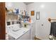 Functional laundry room with washer, dryer, and ample shelving at 3970 Kissimmee Park Rd, St Cloud, FL 34772