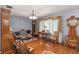 Elegant living room with hardwood floors, vintage furniture, and large windows at 3970 Kissimmee Park Rd, St Cloud, FL 34772