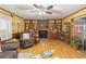 Spacious living room with hardwood floors, a brick fireplace, and built-in shelving at 3970 Kissimmee Park Rd, St Cloud, FL 34772