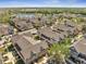An aerial view shows colorful neighborhood homes with a serene lake and lush greenery at 4561 Yellowgold E Rd # 107, Kissimmee, FL 34746