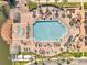 Aerial view of the community pool and outdoor lounge spaces with manicured landscaping at 4561 Yellowgold E Rd # 107, Kissimmee, FL 34746