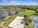 Aerial view of community lake, volleyball and tennis courts and lush green space at 4561 Yellowgold E Rd # 107, Kissimmee, FL 34746
