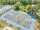 Aerial view of basketball court with blue accents and player for recreational enjoyment at 4561 Yellowgold E Rd # 107, Kissimmee, FL 34746