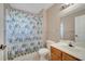 Bright bathroom featuring a white toilet and shower with a colorful curtain at 4561 Yellowgold E Rd # 107, Kissimmee, FL 34746