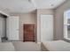 Bedroom with a tall wooden dresser, neutral paint, and closet space at 4561 Yellowgold E Rd # 107, Kissimmee, FL 34746