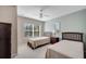 Inviting bedroom featuring two twin beds, a fan and natural light at 4561 Yellowgold E Rd # 107, Kissimmee, FL 34746