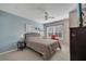 Comfortable bedroom with blue accent wall, ceiling fan, and window overlooking the property at 4561 Yellowgold E Rd # 107, Kissimmee, FL 34746