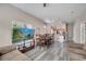Inviting living area with wood-look floors, ceiling lighting, and open access to the kitchen at 4561 Yellowgold E Rd # 107, Kissimmee, FL 34746