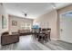 Open-concept living area with gray flooring, a ceiling fan, large window, and stylish furnishings at 4561 Yellowgold E Rd # 107, Kissimmee, FL 34746