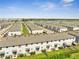 Aerial view showcasing townhomes, new construction, and the surrounding community at 4672 Tribute Trl, Kissimmee, FL 34746