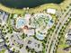 A birds eye view of the neighborhood pool, lazy river, mini golf, splashpad, and other amenities, with parking and a small lake at 4672 Tribute Trl, Kissimmee, FL 34746
